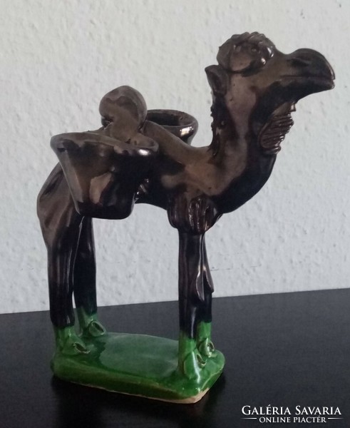 An old ceramic camel (dromedary) figurine with the effect of a bronze statue is for sale