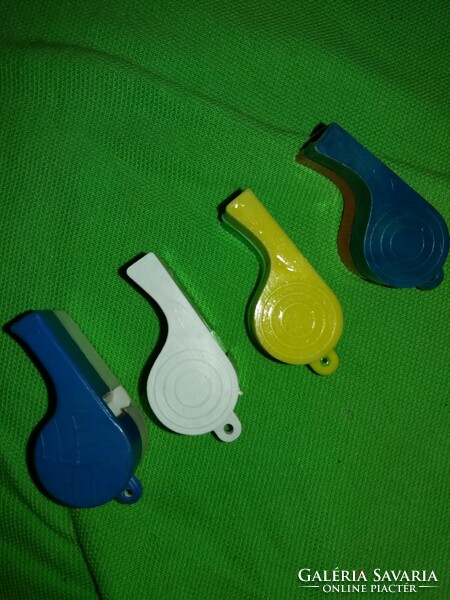 Old traffic goods bazaar colored plastic whistles according to the pictures