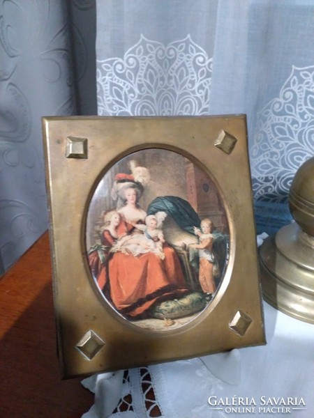 Colored embossed pictures in an antique brass frame with a portrait of Queen Marie Antoinette of France