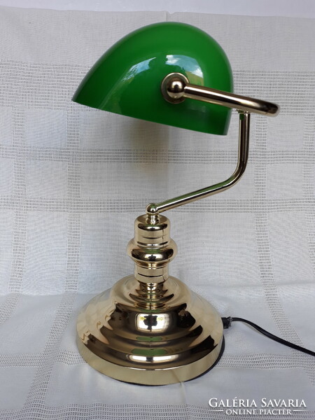 A beautiful copper bank lamp with a green glass shade