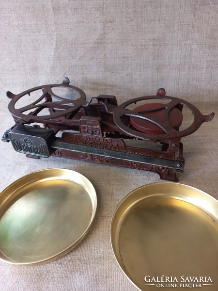 An old Matyó style kitchen scale with a copper pan on the side