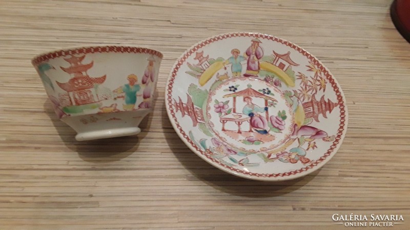 Antique oriental pattern faience tea cup with small plate.