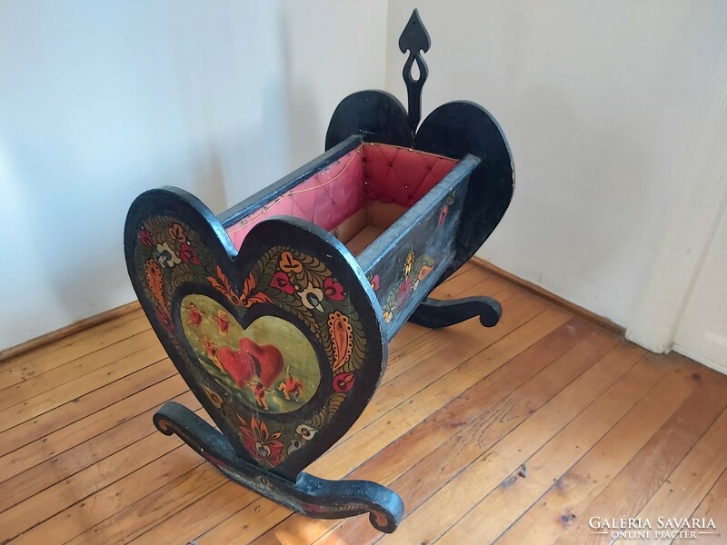 Old, richly painted wooden cradle
