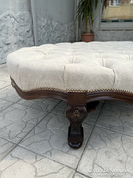 Large oval ottoman, pouffe, seat on carved legs, with buttoned seat