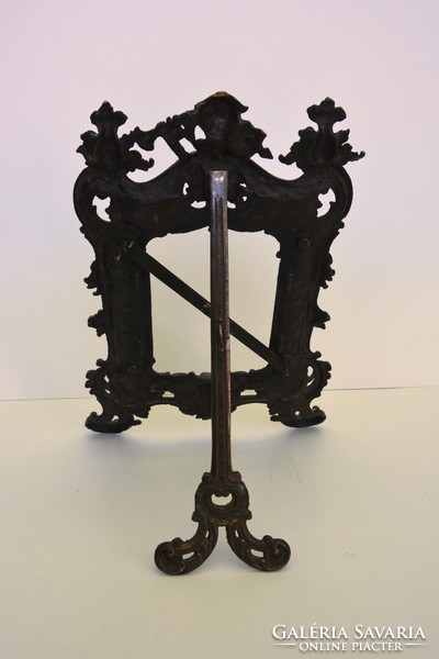 Decorative cast iron picture frame with angelic, lily motifs