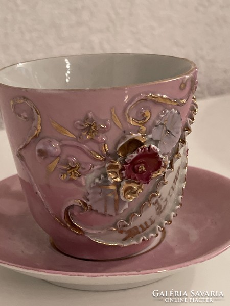 Antique embossed porcelain mug with small plate.