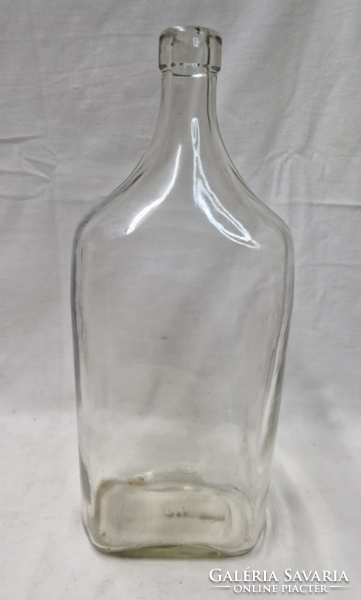 Old thick-walled two-liter bottle with a stopper, with the inscription 