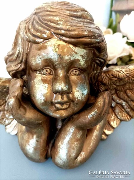 Gilded, elbowing angel