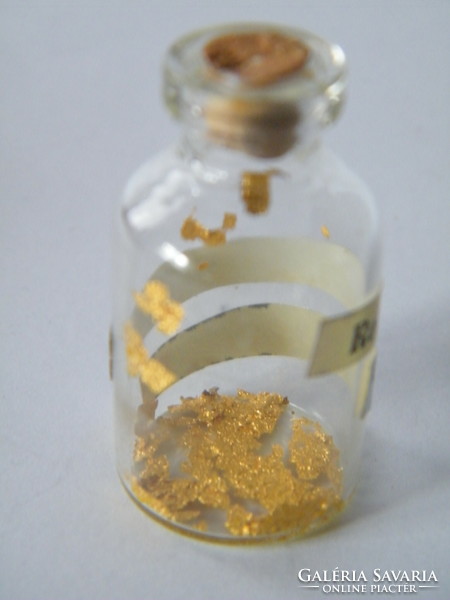 Small bottle containing 24 carat gold