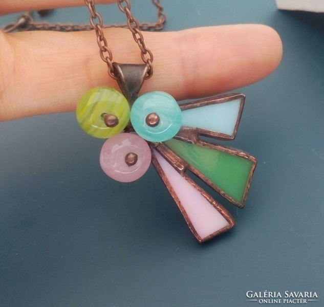 A glass jewelry pendant made of pastel colors, a handcrafted work