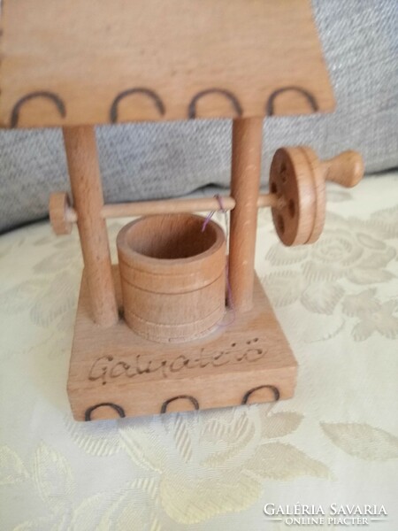 A wooden well with a wheel is beautiful