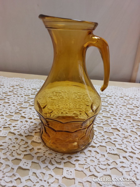 Amber-colored, glass jug, spout with a beautiful pattern