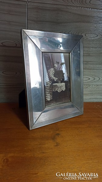 Large silver-plated picture frame with an antique photo