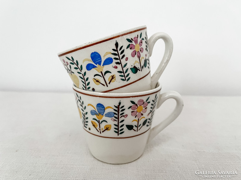 A pair of granite coffee cups - a pair of mocha cups with a small flower pattern
