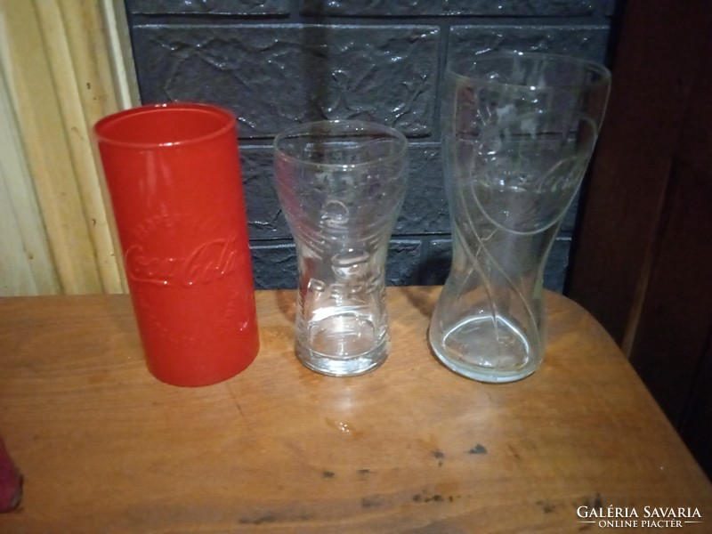 3 drinking glasses 2 Coke a Cola and 1 Pepsi