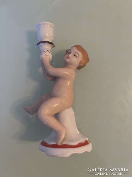 A beautifully painted porcelain candlestick statue for your collection.